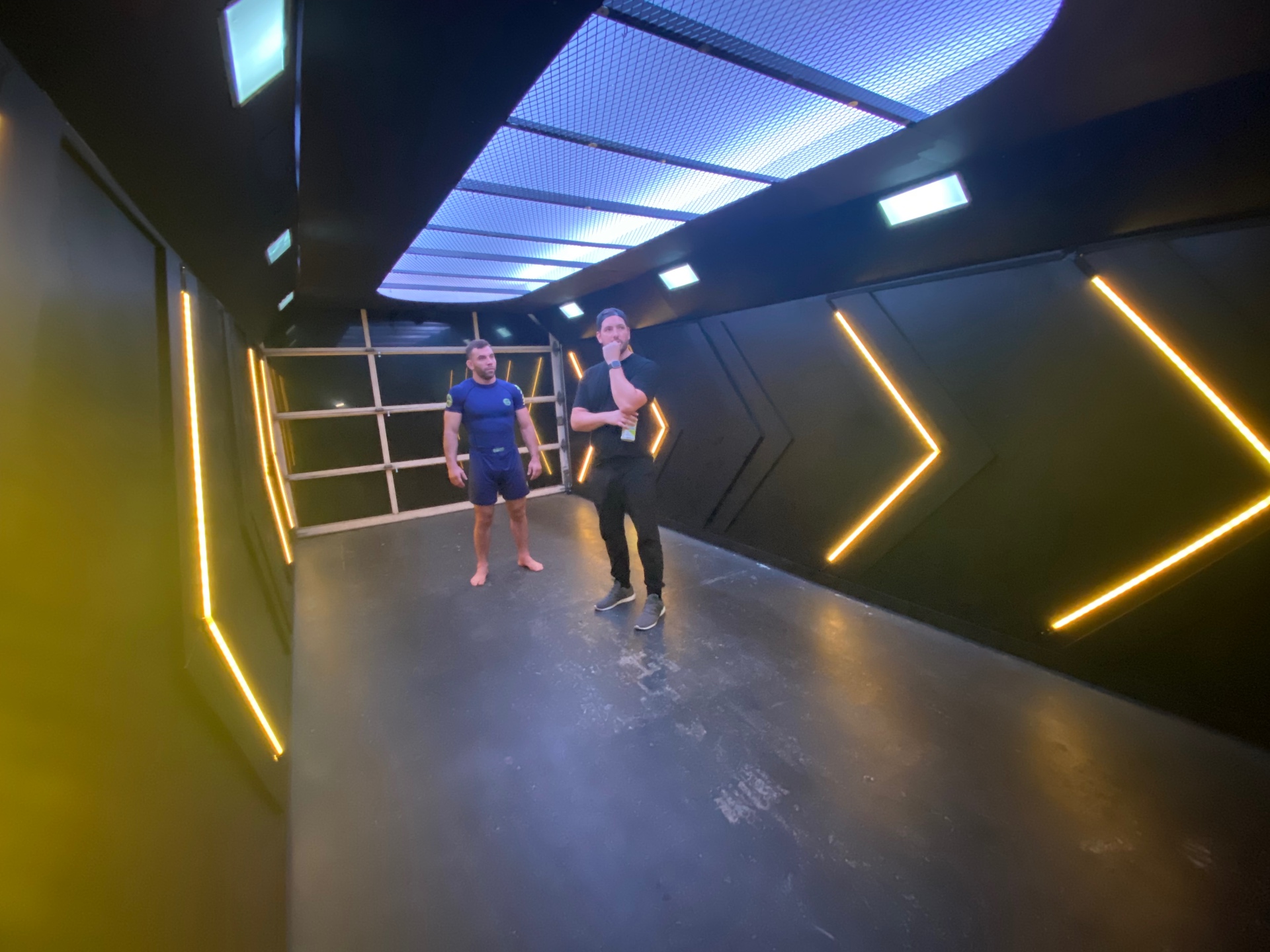 Spencer and the athlete going over the take inside the custom booth