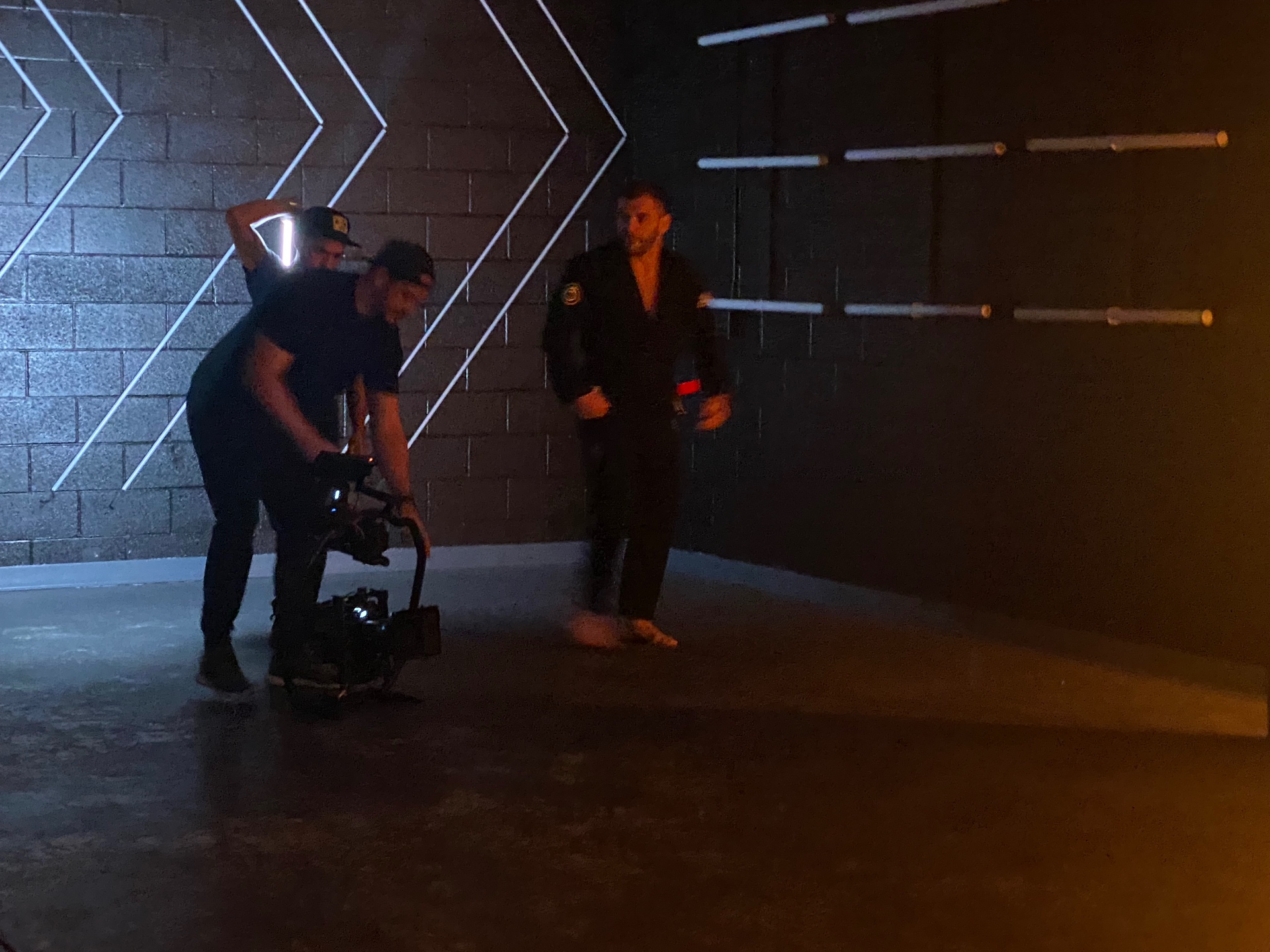 Spencer working the camera rig on a dimly lit set